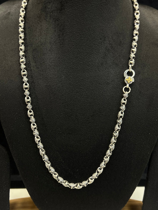 Silver chain necklace on a black mannequin