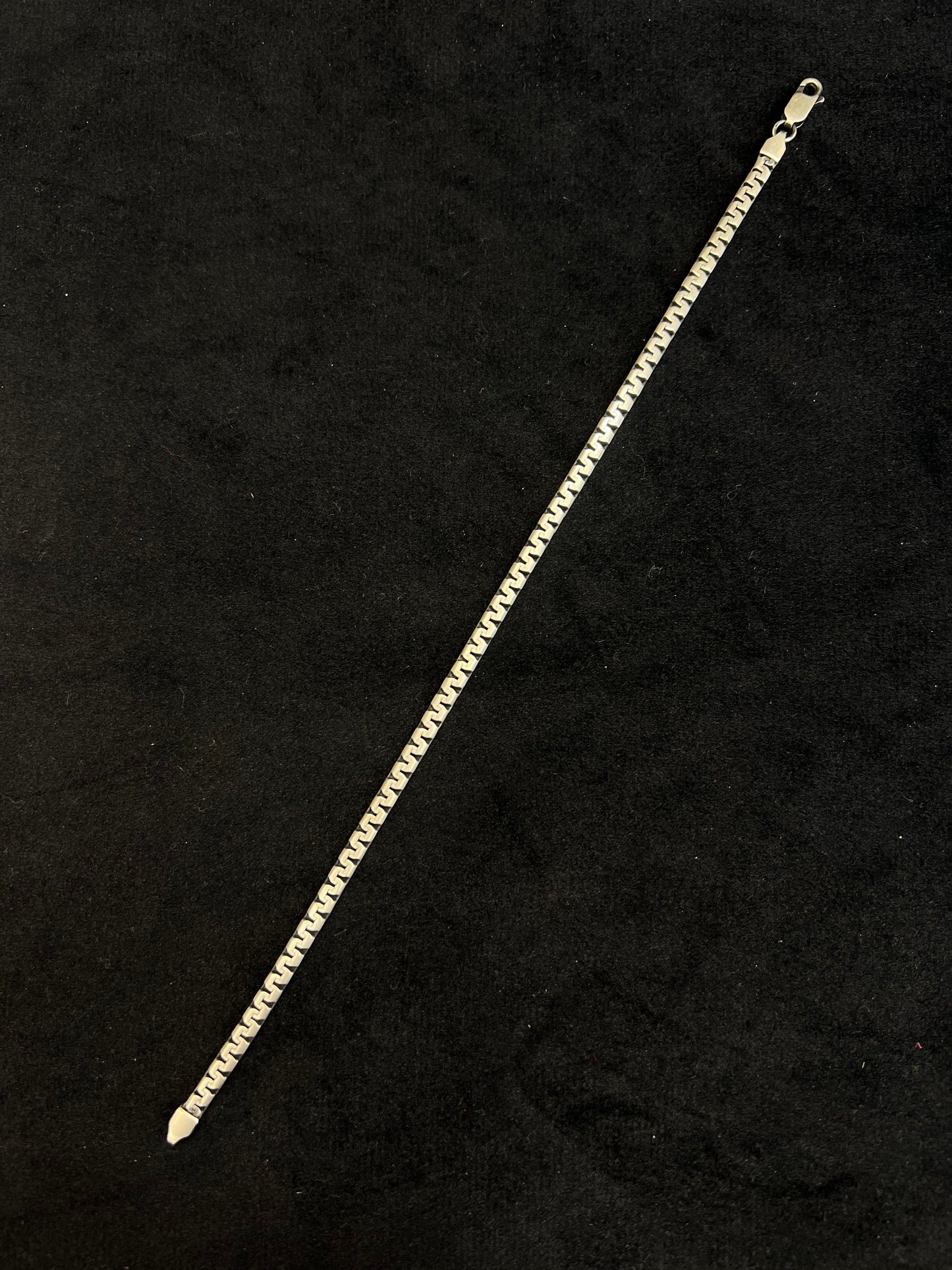 Gold chain bracelet on a black background