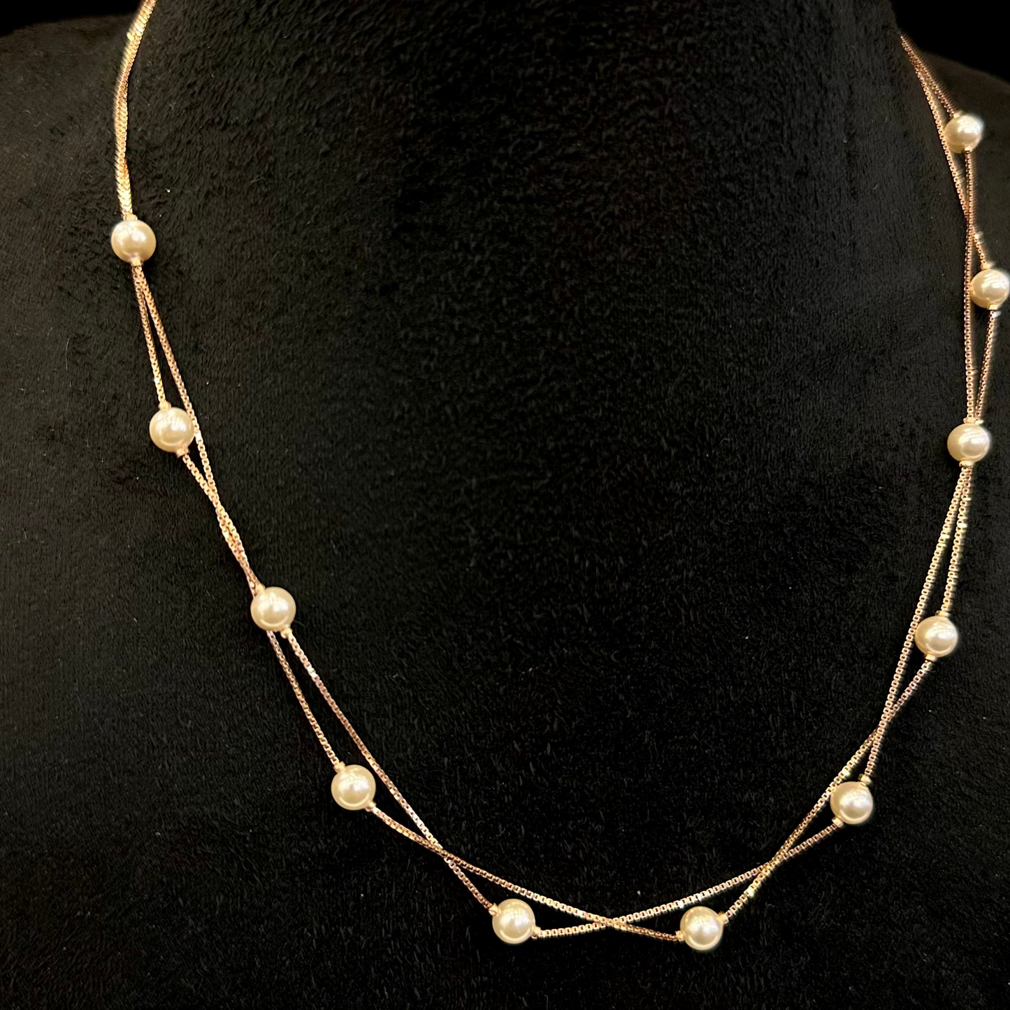 Pearl necklace on a black mannequin bust