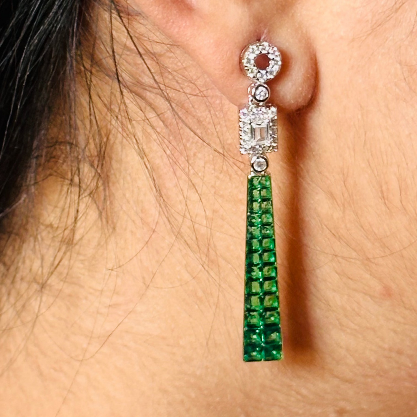 a pair of elegant, long tassel earrings. The earrings feature a combination of sparkling cubic zirconia and deep-colored gemstone tassels, set in silver.
