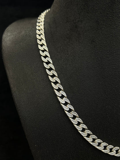 Silver chain necklace on a black stand