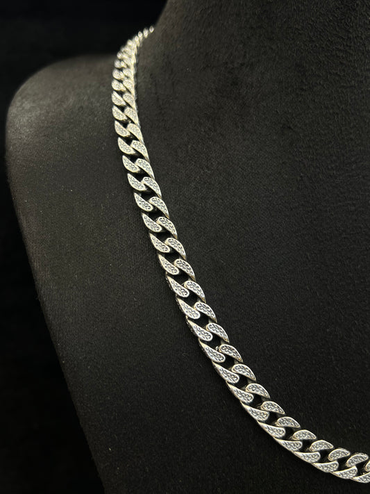 Silver chain necklace on a black stand