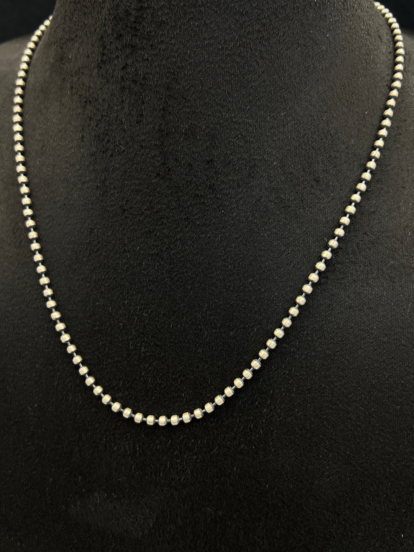 Pearl necklace on a black mannequin