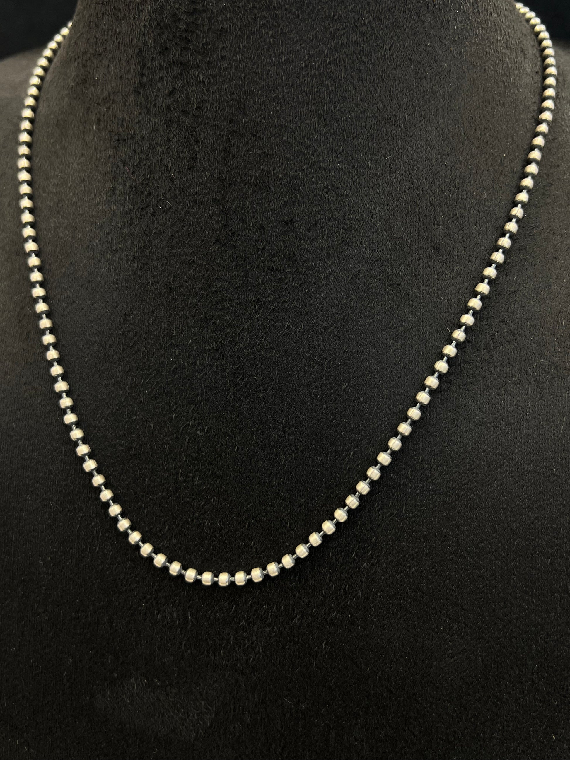 Pearl necklace on a black mannequin