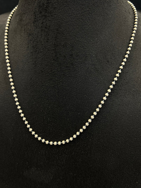 Pearl necklace on a black mannequin