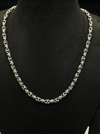 Silver chain necklace on a black mannequin