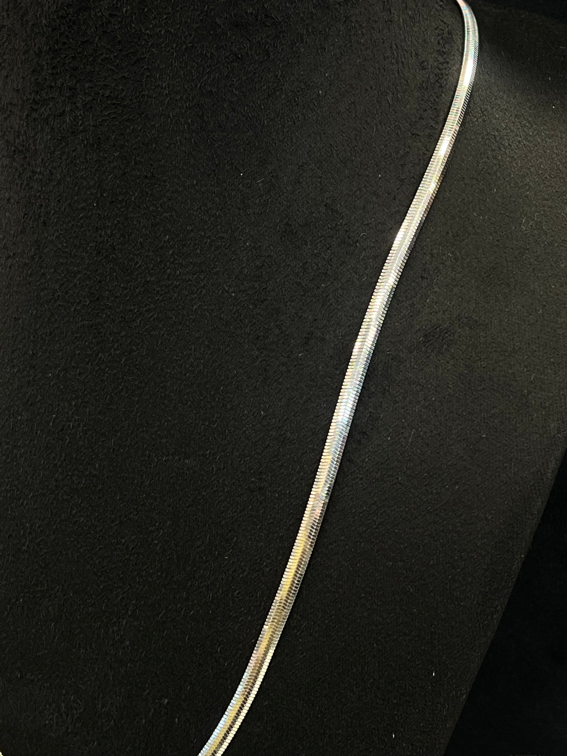 Silver necklace on a black background