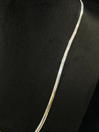 Silver necklace on a black background