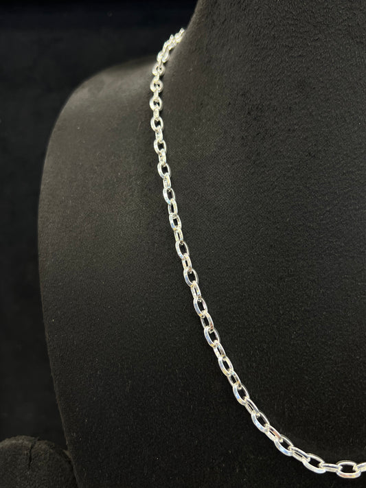 Silver chain necklace on a black mannequin bust