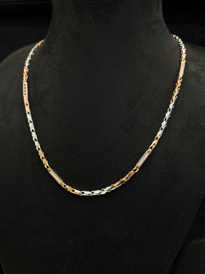 Gold and silver chain necklace on a black mannequin