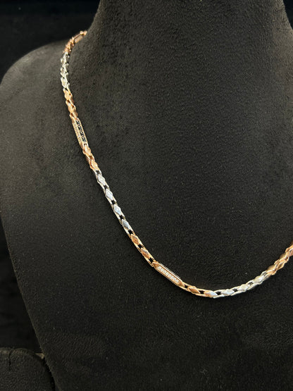 Gold and silver chain on a black mannequin bust