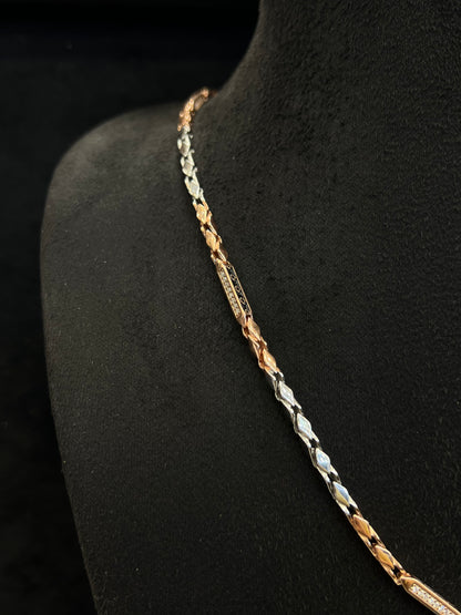Three-colored chain necklace on a black mannequin.