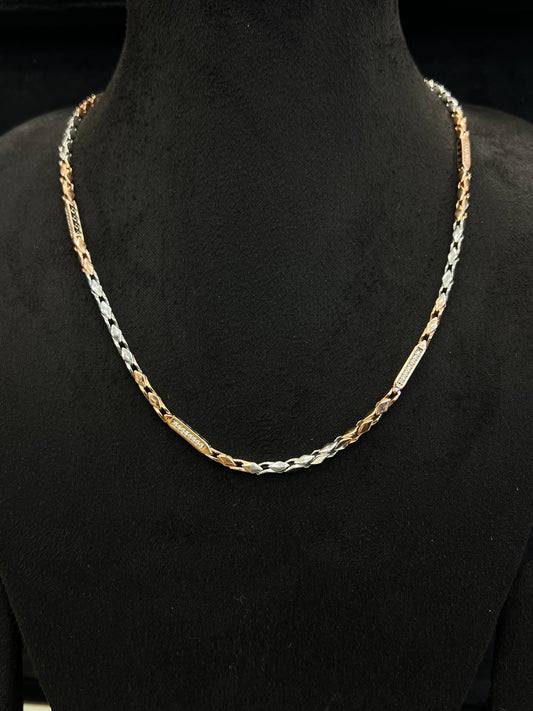 Two-tone gold and silver chain necklace on a black mannequin.