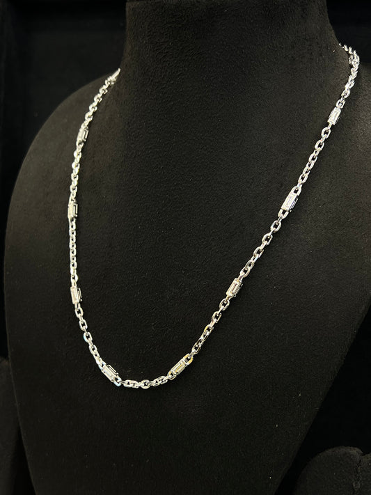 Silver chain necklace on a black mannequin bust