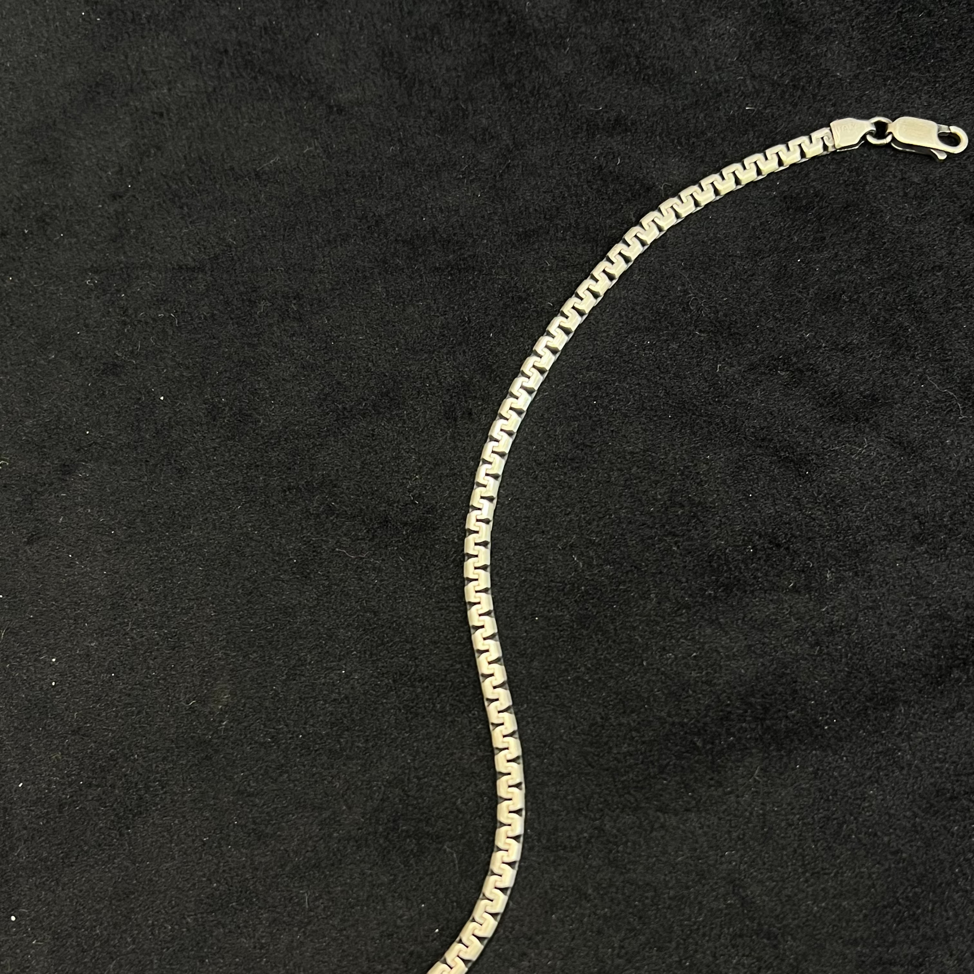 Gold chain bracelet on a black background