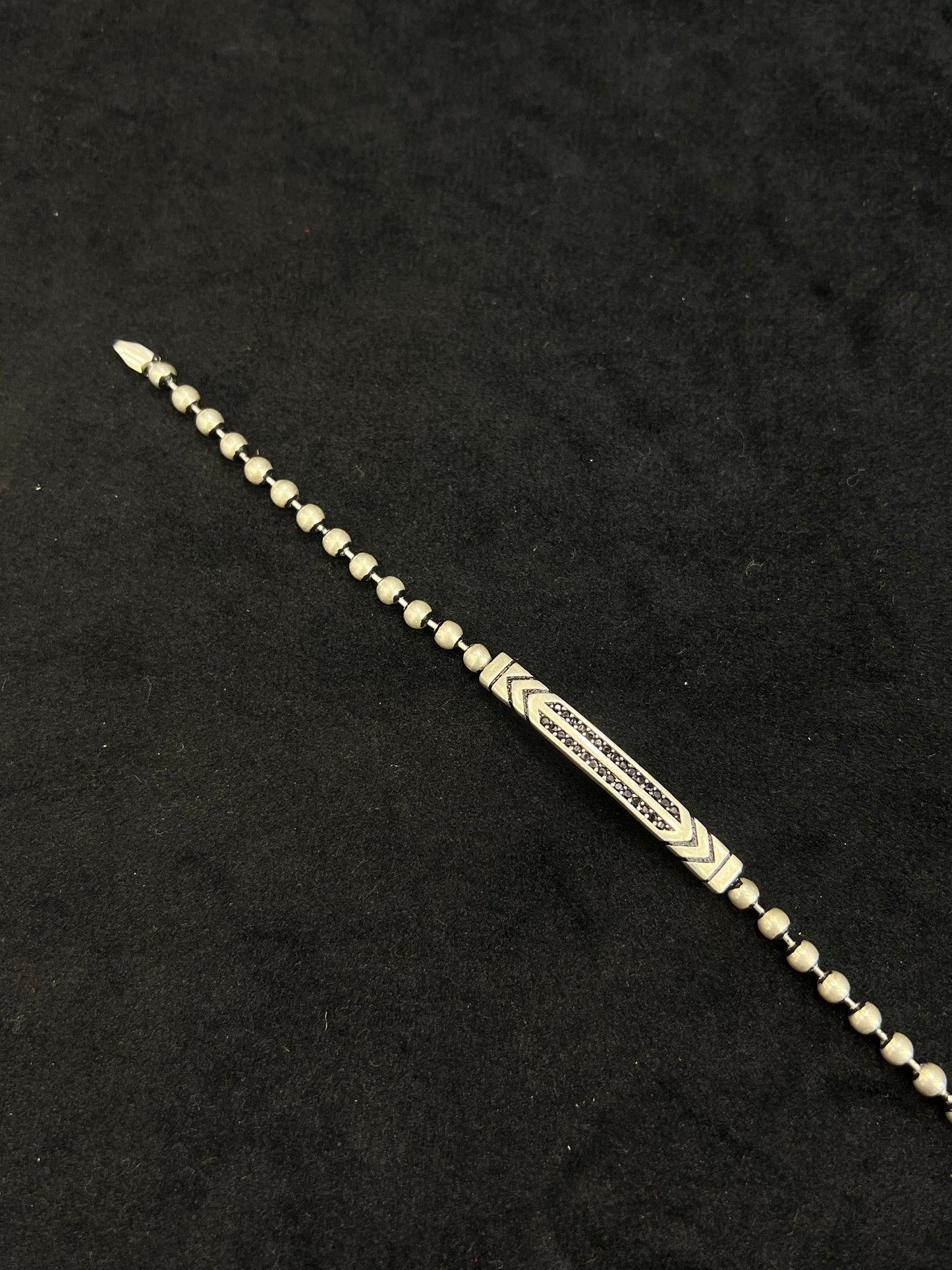 Decorative metal hairpin on a black background