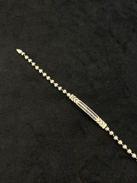 Decorative metal hairpin on a black background
