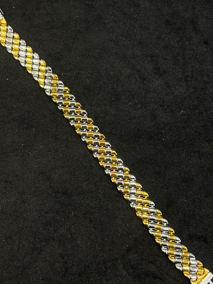 Two-tone gold and silver bracelet on a black background