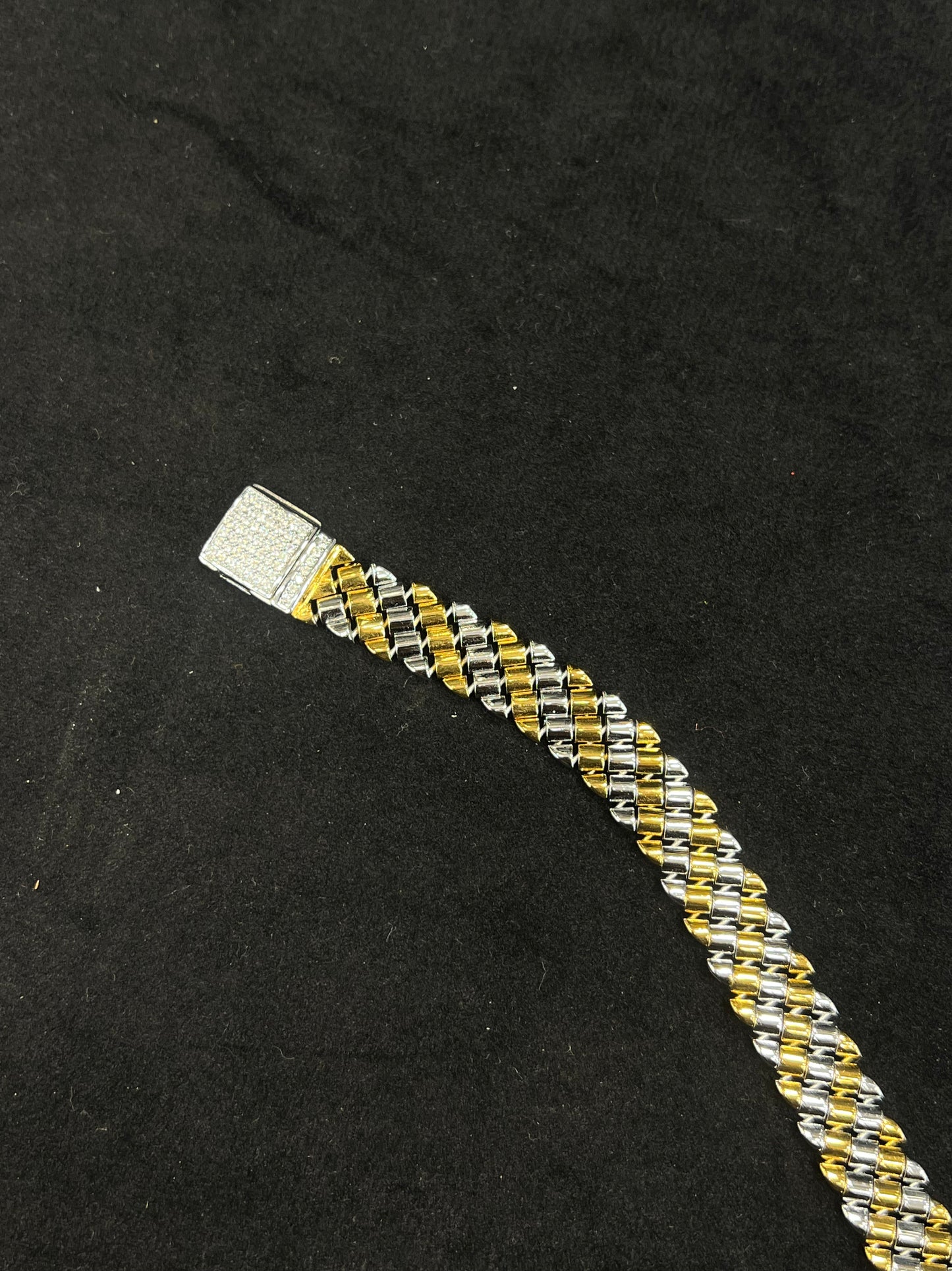 Two-tone braided bracelet on a black background