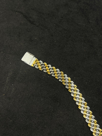 Two-tone braided bracelet on a black background