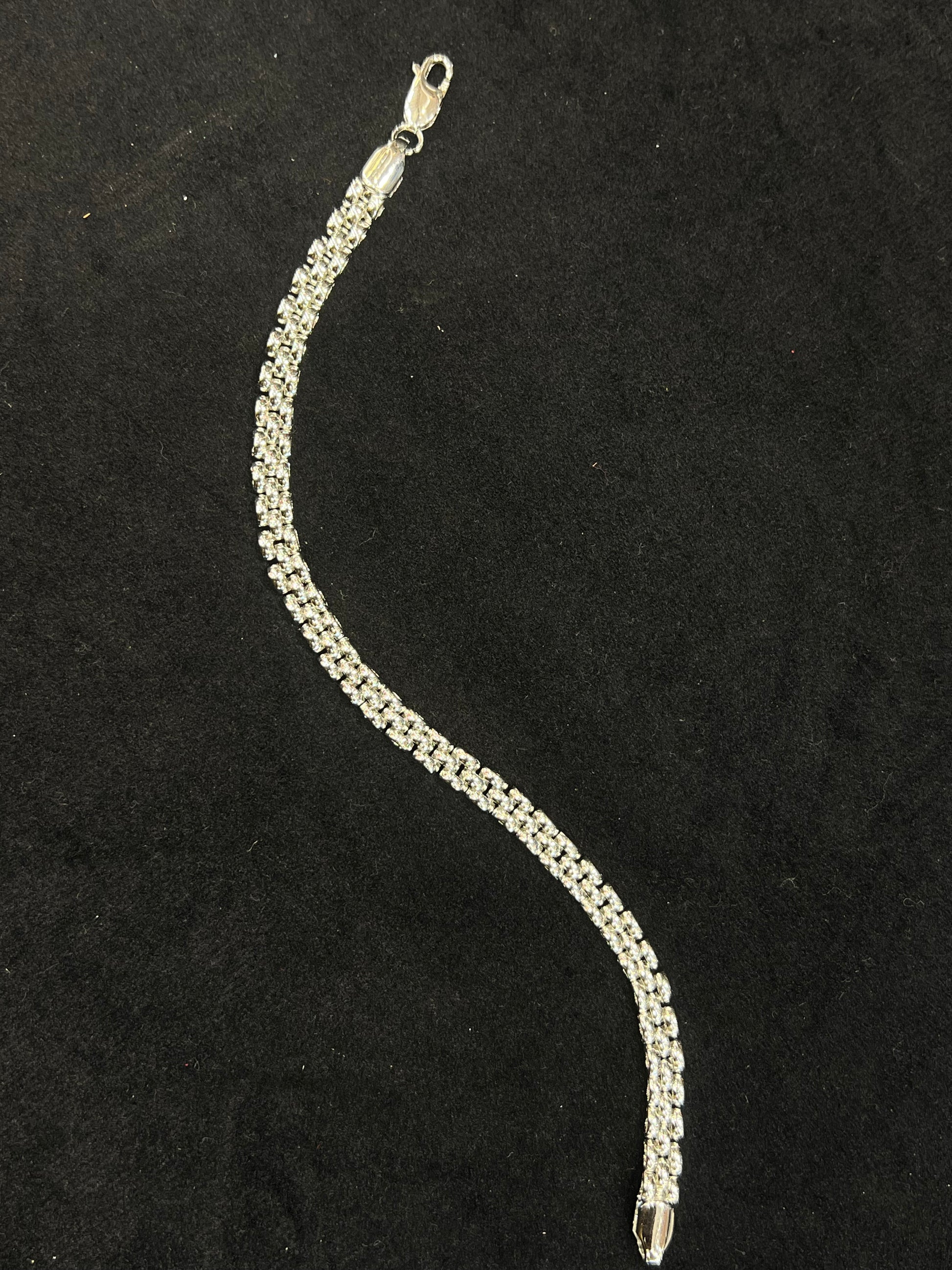 Silver bracelet on a black background