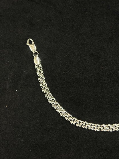 Silver bracelet on a black background