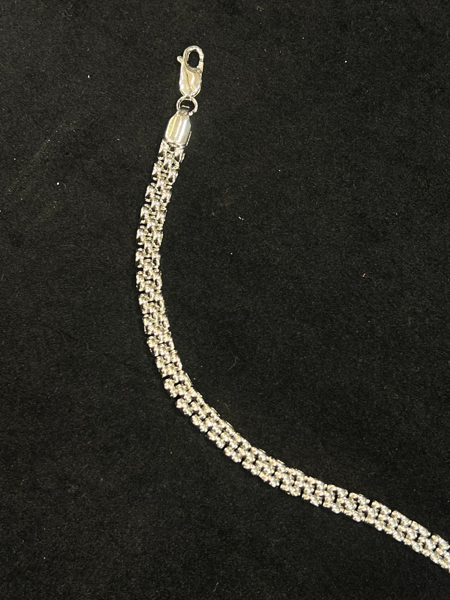 Silver chain necklace on a black background