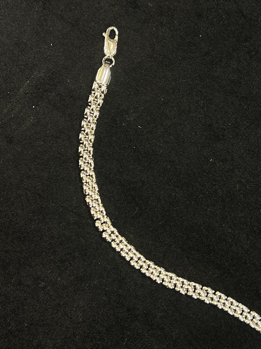 Silver chain necklace on a black background