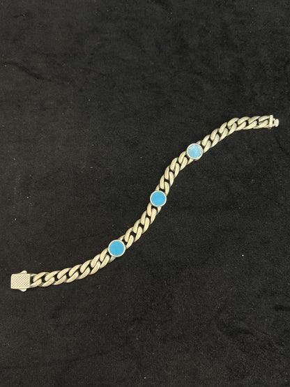 chain bracelet with blue gemstones on a black background