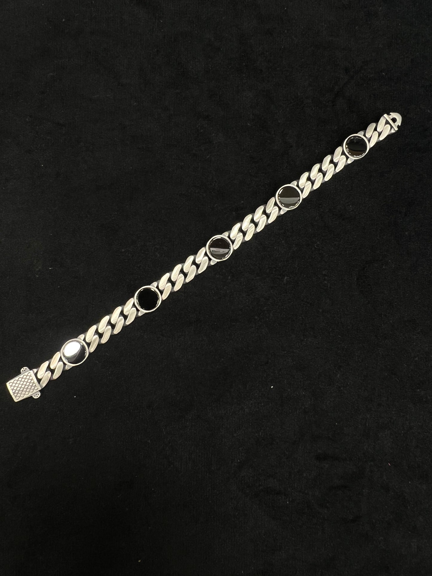 Silver chain bracelet on a black background