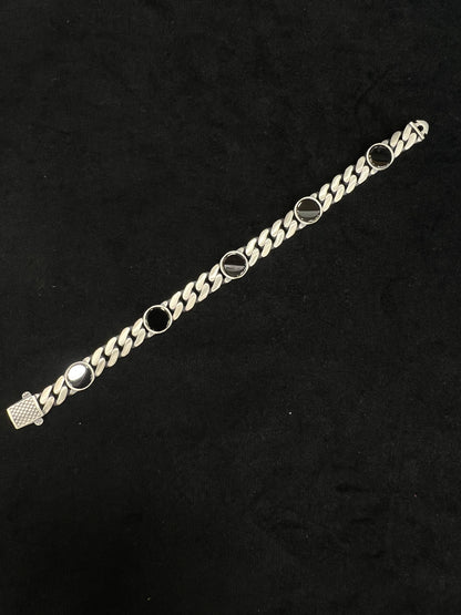 Silver chain bracelet on a black background