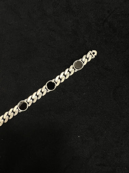 Gold chain bracelet on a black background