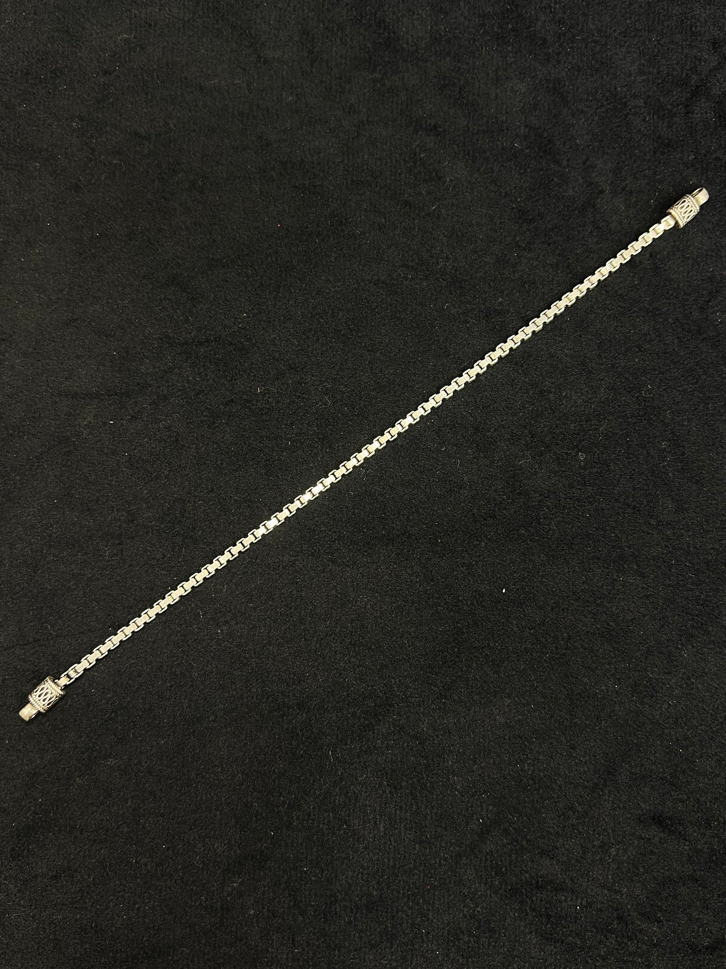 Gold chain bracelet on a black background