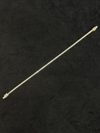 Gold chain bracelet on a black background