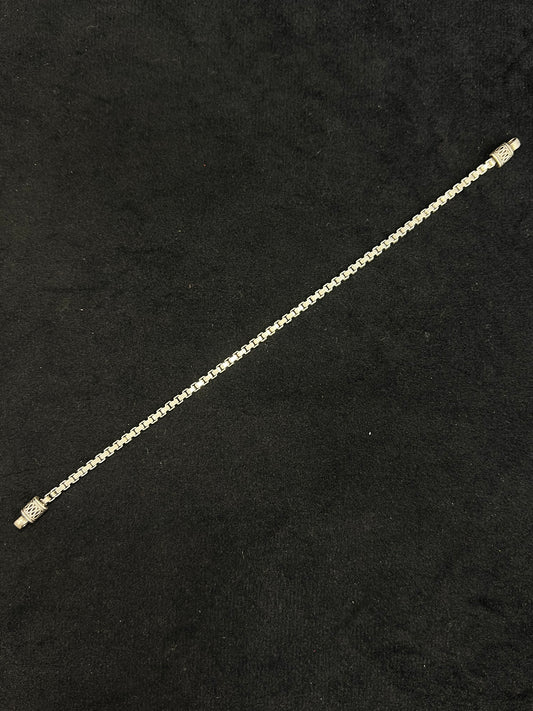 Gold chain bracelet on a black background