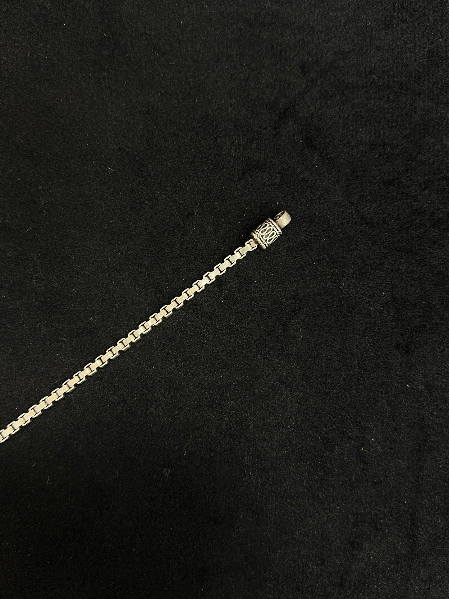 Gold chain bracelet on a black background