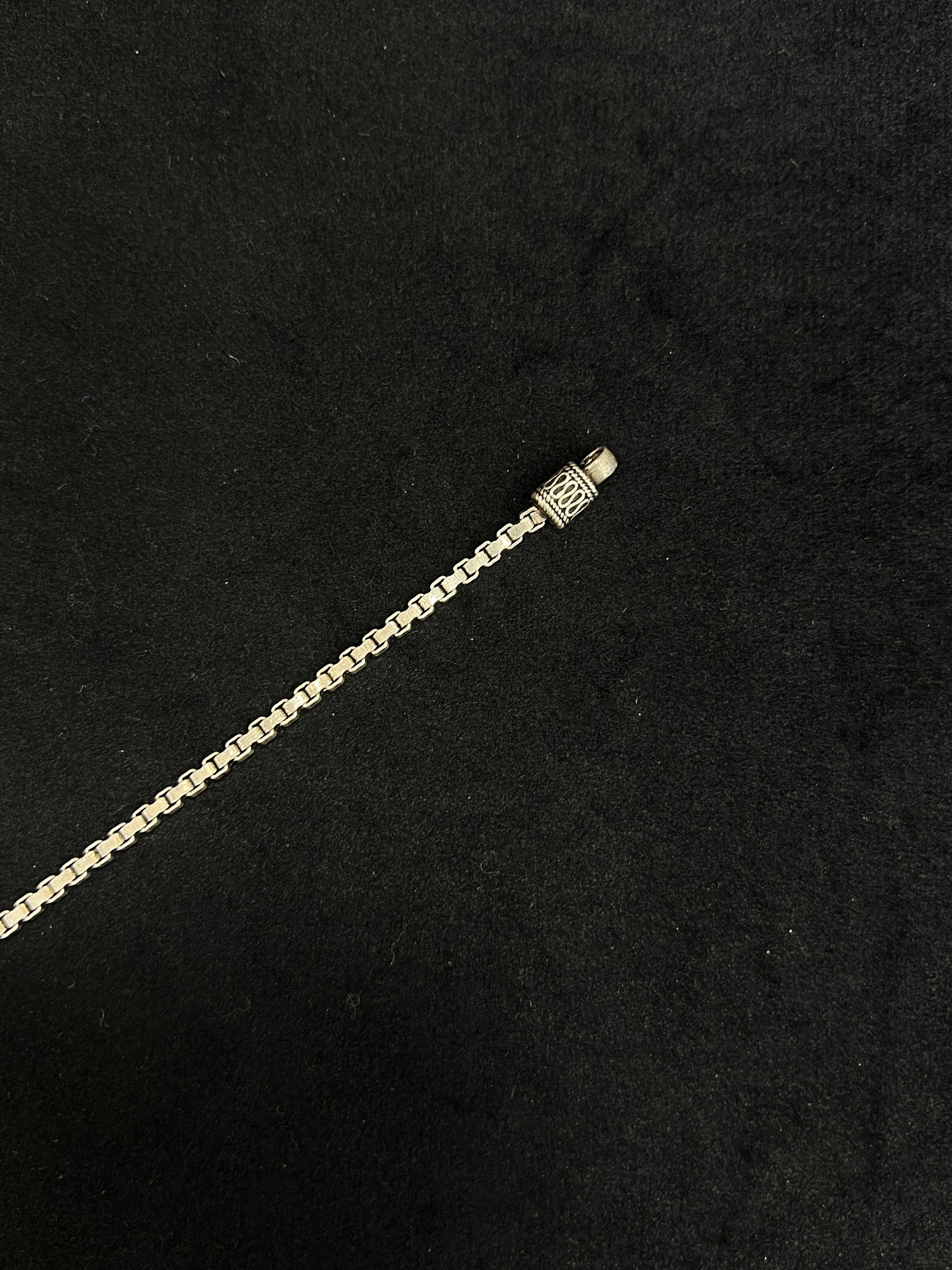 Gold chain bracelet on a black background