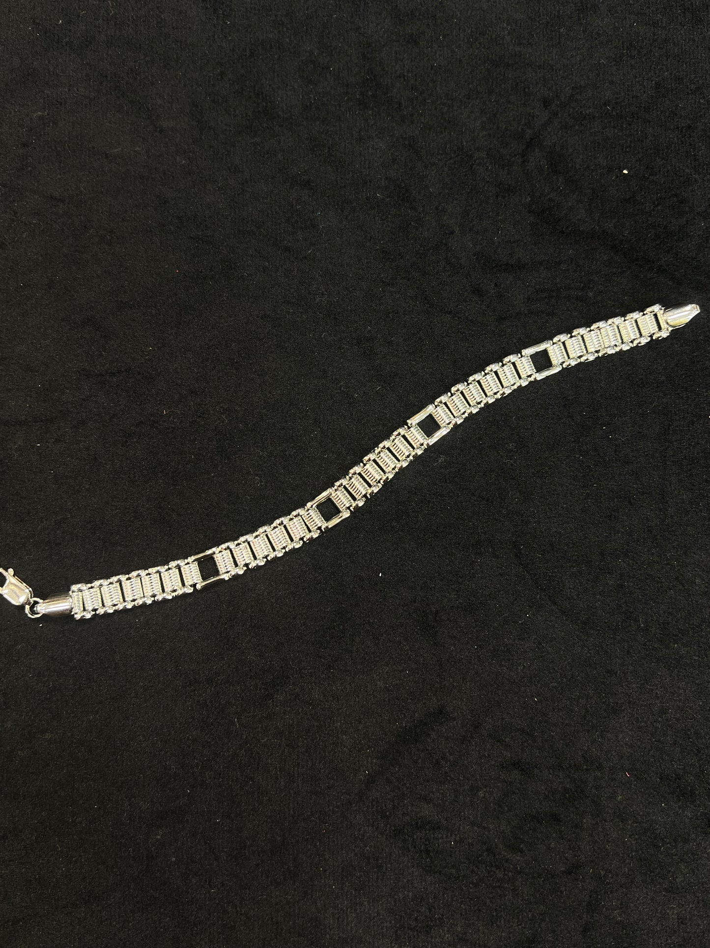 Silver bracelet on a black fabric background
