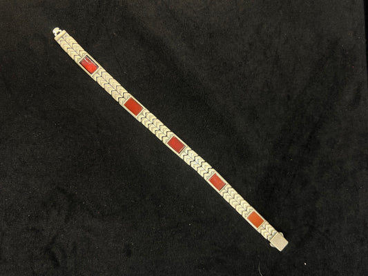 Bracelet with red and gold square pattern on a black background