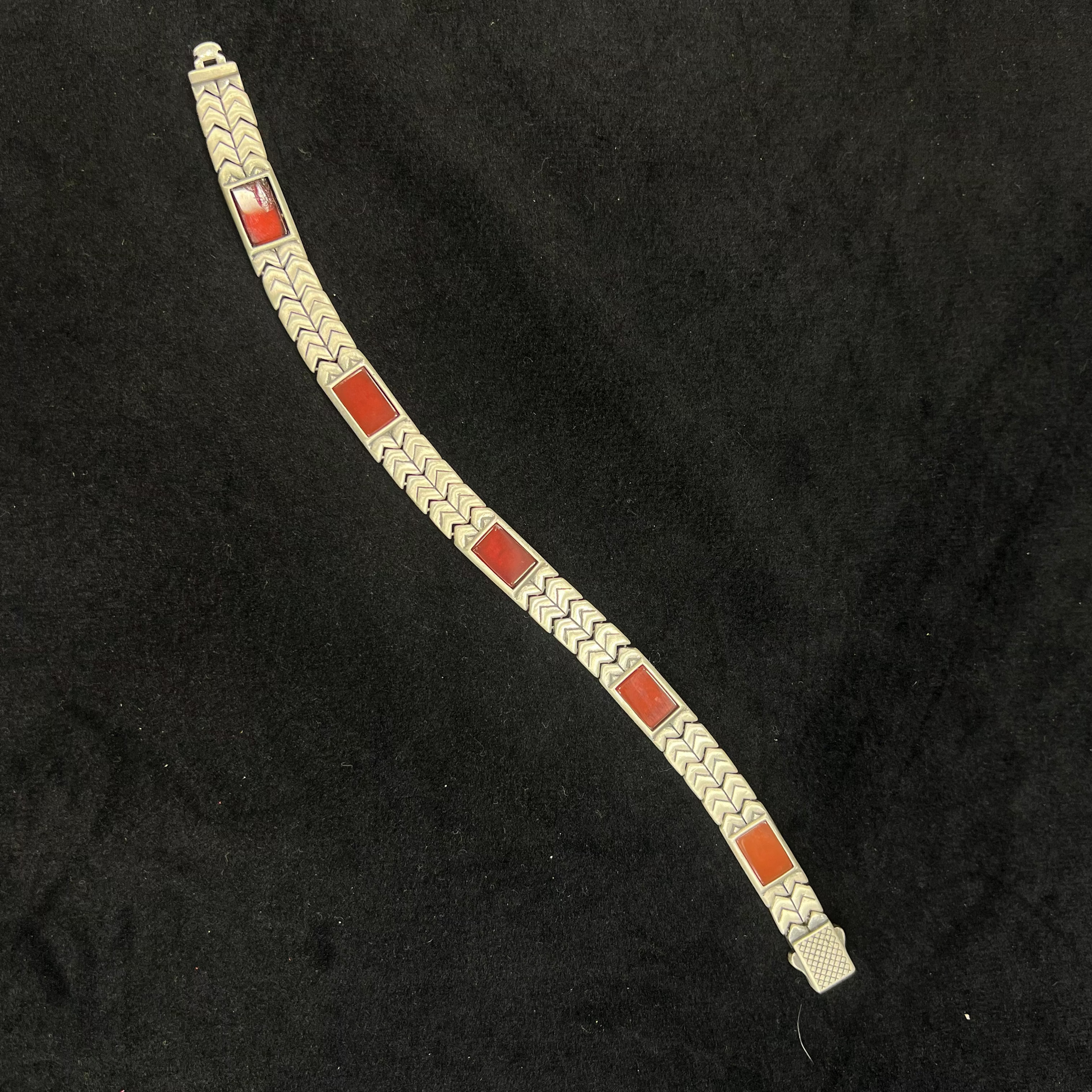 Bracelet with red and silver design on a black background