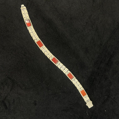 Bracelet with red and silver design on a black background