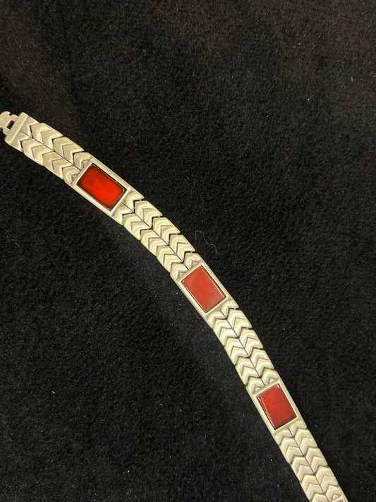 Bracelet with red square stones on a black background