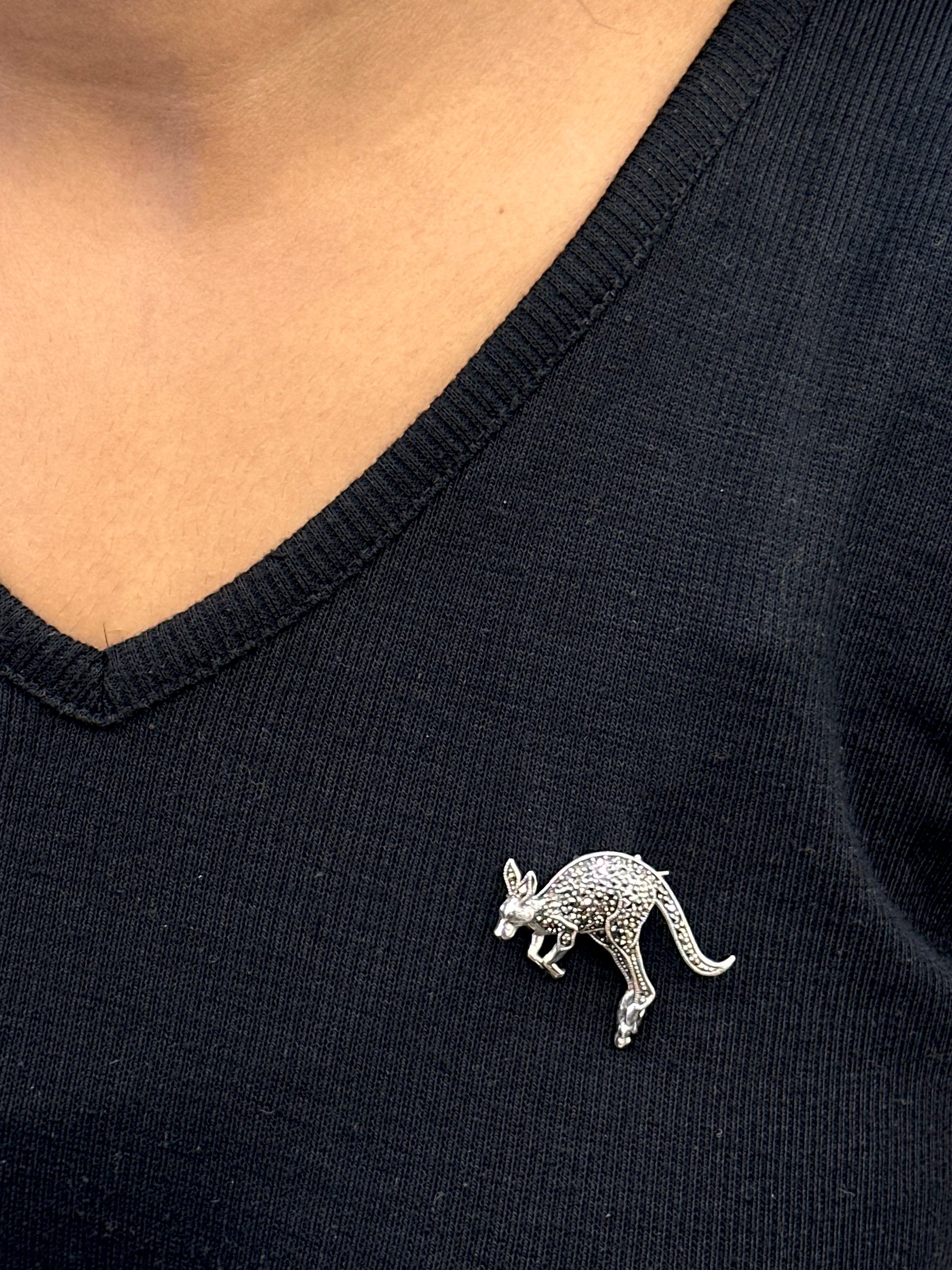 Silver kangaroo brooch on a black shirt