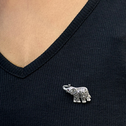 Silver elephant brooch on a black shirt