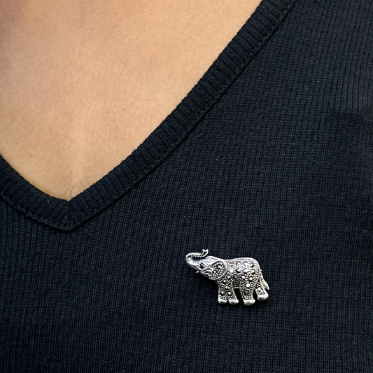Silver elephant brooch on a black shirt