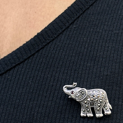 Silver elephant brooch on a black shirt