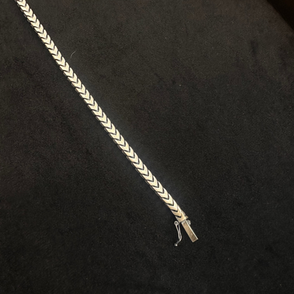 Silver braided bracelet on a black background