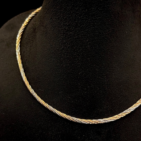 Gold necklace on a black mannequin bust