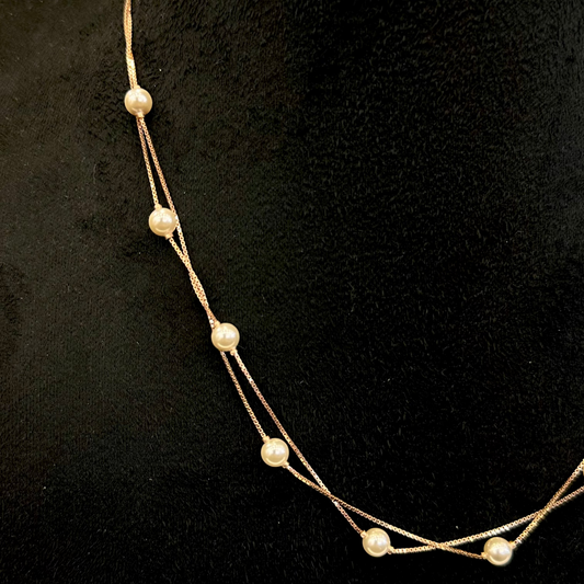 Pearl necklace on a black background