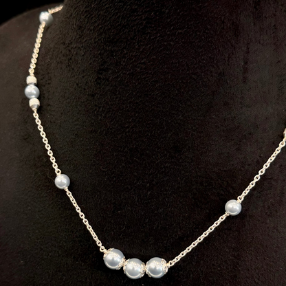 Pearl necklace on a black mannequin bust